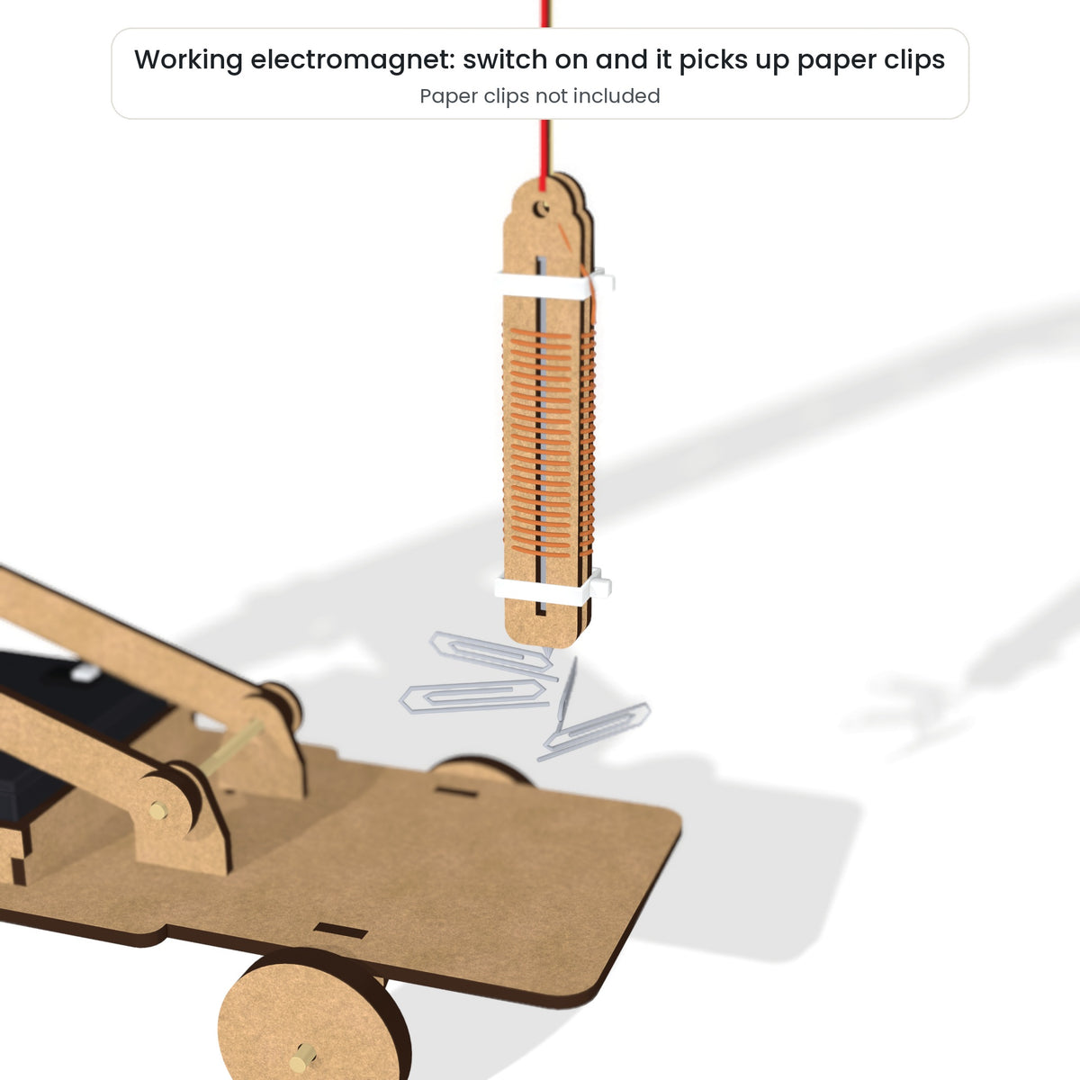 The kit's working electromagnet lifting paper clips while the switch is on. Paper clips are not included in the box